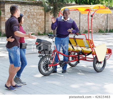 African American driver of pedicab offering city tour African American driver of pedicab offering city tour 42615463