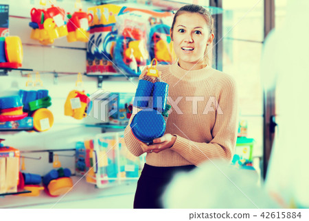 Woman buying plastic toys Woman buying plastic toys 42615884