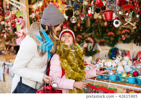 Girl with mom buying decorations 42615905