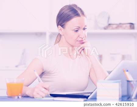 Woman working on laptop Woman working on laptop 42615910