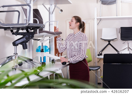 Girl searching new chair in store 42616207