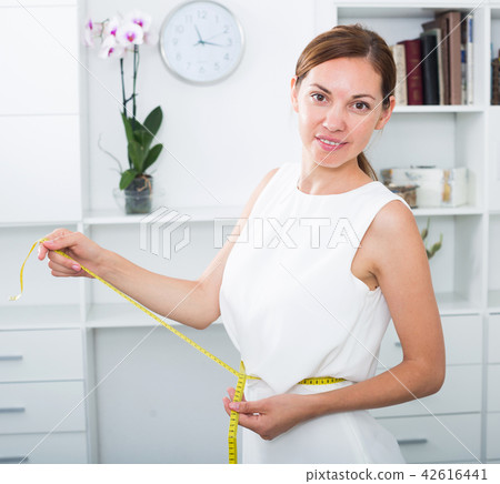woman with measuring tape around waist 42616441