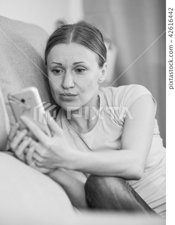 Upset woman with phone 42616442