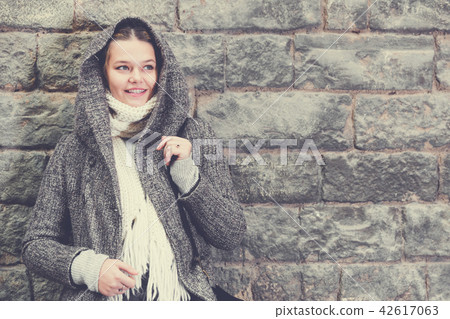 teenager girl in hood near wall 42617063