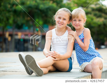 Two smiling little girls embracing Two smiling little girls embracing 42617457