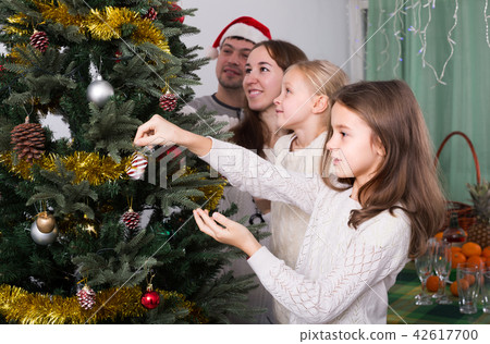 Family decorating Christmas tree at home. 42617700