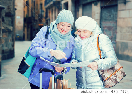 Elderly women tourists with city guide Elderly women tourists with city guide 42617974