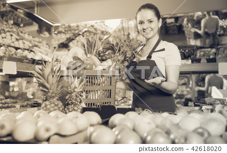 saleswoman with variety of vegetables and fruits saleswoman with variety of vegetables and fruits 42618020