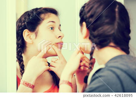 Girl cleaning pores 42618095
