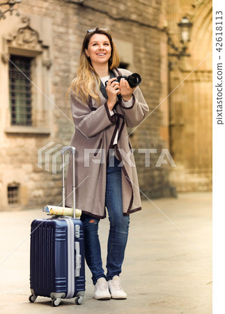 Girl holding camera in hands and photographing in the city Girl holding camera in hands and photographing in the city 42618113