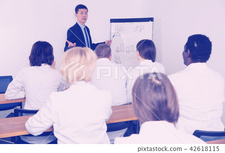 Smiling male giving presentation for medics 42618115