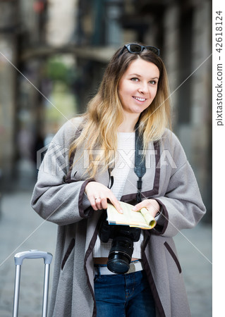 Blond ordinary girl holding brochure in hands 42618124