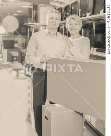 Smiling husband and wife purchased and packed appliances 42618138