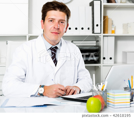Dentist working in medical Center at the laptop Dentist working in medical Center at the laptop 42618195