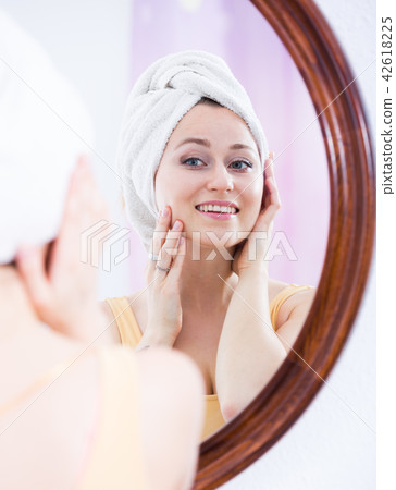 woman looking at mirror 42618225