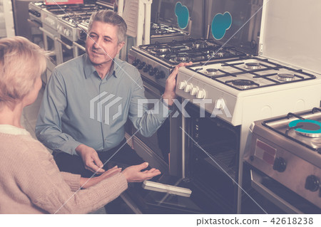 Family of two are buying in center of household appliances the p 42618238