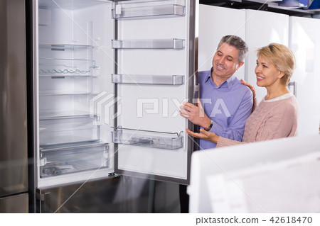 Husband and wife together in shop of household appliances Husband and wife together in shop of household appliances 42618470