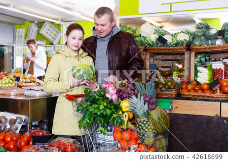 Happy girl with father choosing cauliflower Happy girl with father choosing cauliflower 42618699