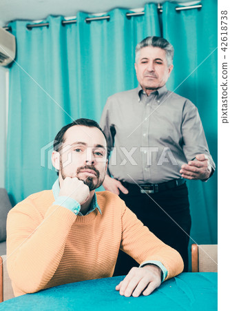 Adult father teaches his son 42618738