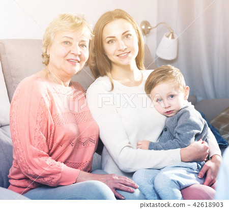 Two women and toddler are resting together and posing Two women and toddler are resting together and posing 42618903