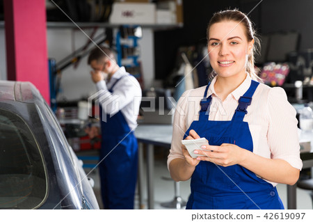 Female mechanic recording list of works 42619097