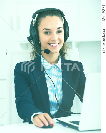 girl with headset and laptop in office. girl with headset and laptop in office. 42619271