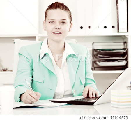 Female is working with documents and laptop 42619273
