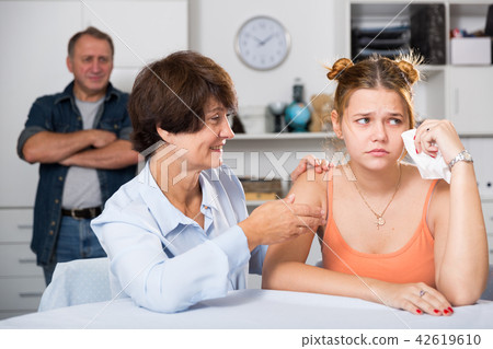 Adult woman is carefully talking with a sad daughter 42619610