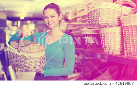 woman demonstrates the choice of the picnic basket woman demonstrates the choice of the picnic basket 42619867