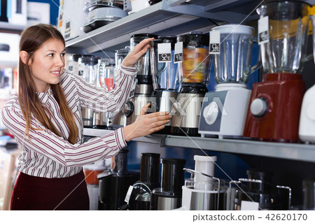 Young woman choosing blender in household appliances shop 42620170