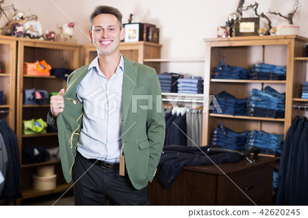 Customer examining suits 42620245