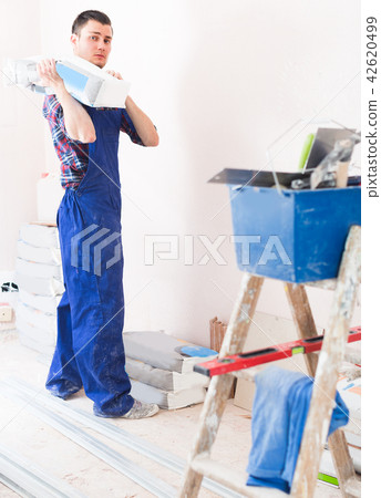 Worker is going to mix putty 42620499