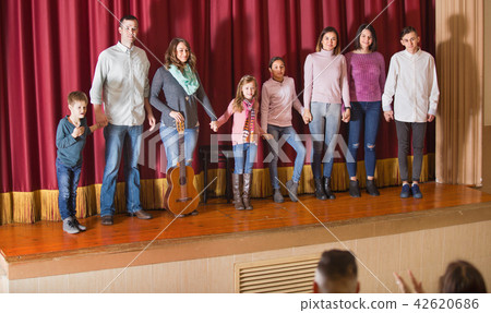 Performers bowing to audience after concert 42620686