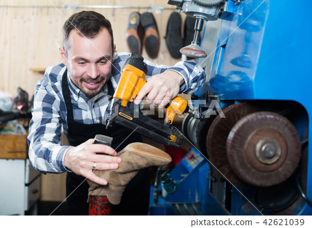 Male worker repairing shoe Male worker repairing shoe 42621039