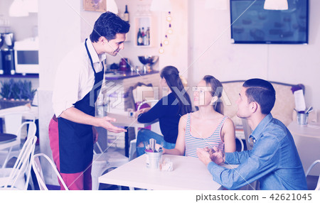 Positive guests of comfy tearoom giving order Positive guests of comfy tearoom giving order 42621045