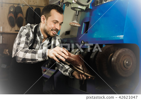Male worker repairing shoe Male worker repairing shoe 42621047