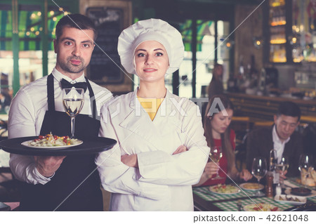 Portrait of male waiter and female cook who are welcoming clients 42621048