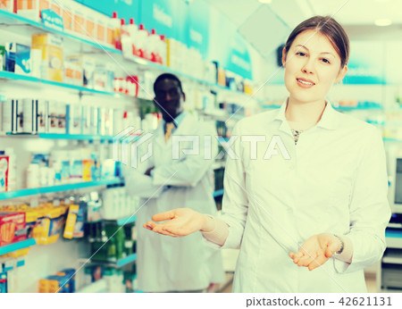 female pharmacist inviting to drugstore female pharmacist inviting to drugstore 42621131