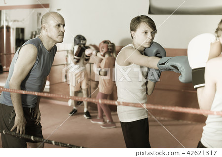 Teenagers at boxing training with instructor 42621317