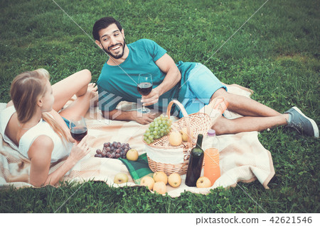 Couple are talking and drinking wine in time picnic outdoor 42621546
