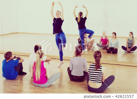 Dance teacher demonstrates new position Dance teacher demonstrates new position 42621557