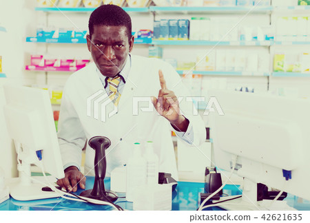 male pharmacist drawing attention of clients 42621635