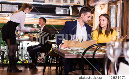 Couple is choosing order for dinner 42621671