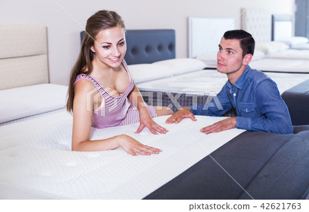 Woman buying mattress Woman buying mattress 42621763