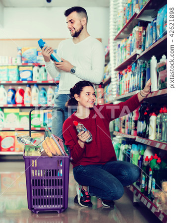 two adult people selecting detergents in the store 42621898