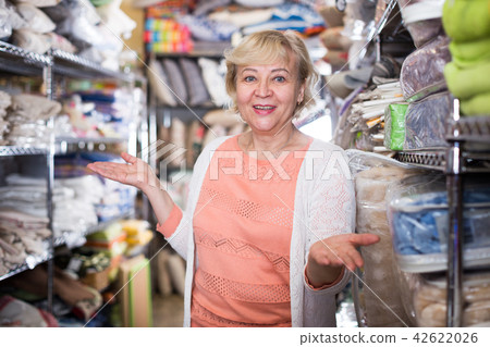 female housewife choosing textile in the store female housewife choosing textile in the store 42622026
