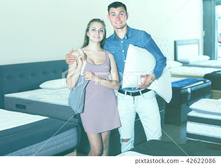 young couple decided to buy a mattress young couple decided to buy a mattress 42622086