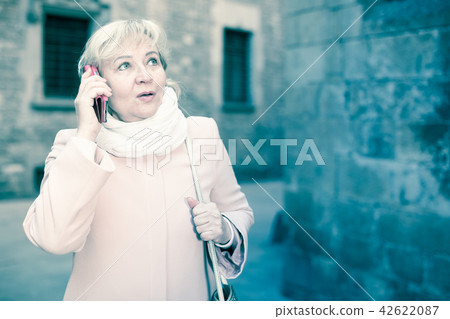 woman talking on mobile phone woman talking on mobile phone 42622087