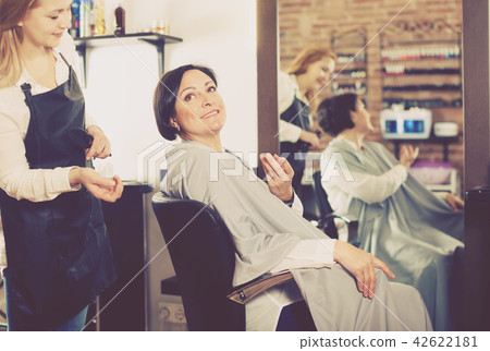 Woman happy with her haircut and young hairdresser 42622181