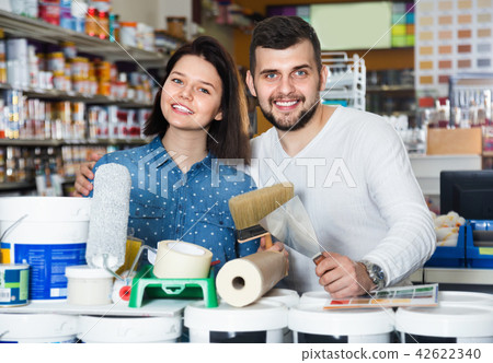 Couple purchasing tools for house improvements in paint supplies store Couple purchasing tools for house improvements in paint supplies store 42622340